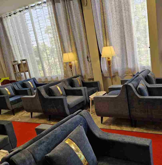 The seating area in Beira Lounge at Djibouti–Ambouli International Airport features comfortable armchairs and tables with floor lamps.