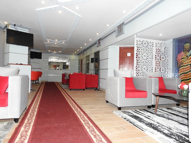 The Beira Lounge at Djibouti–Ambouli International Airport features comfortable seating areas with armchairs and a decorative partition for privacy.
