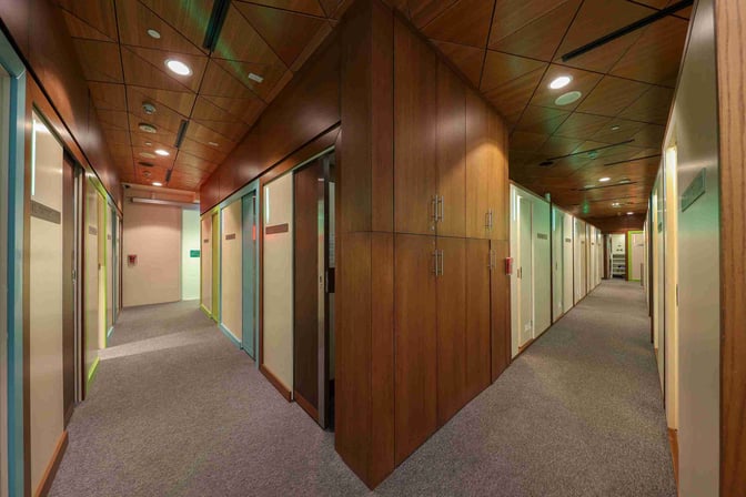 The Sleepover South Node at Doha Hamad International Airport features a hallway with private sleeping pods for travelers.