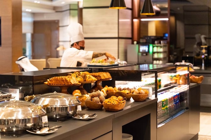 The Ahlan First Class Lounge at Dubai International Airport features a self-serve food station with pastries, hot dishes, and beverages.