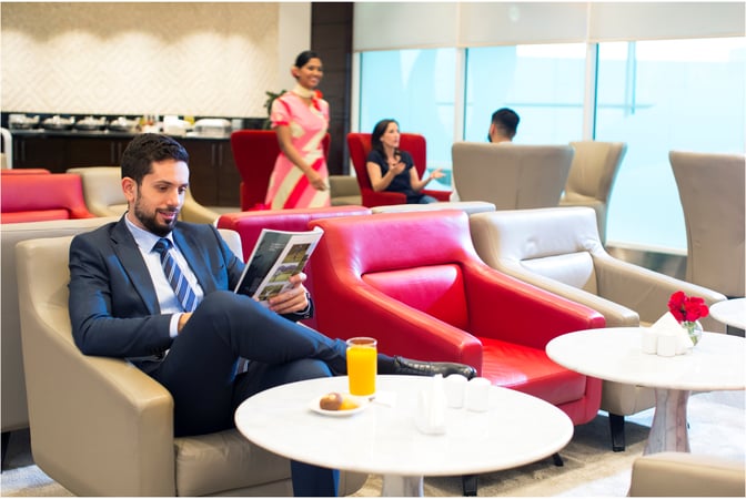 Seating area in marhaba Lounge at Dubai International Airport Concourse D features comfortable chairs and tables with refreshments available for guests.