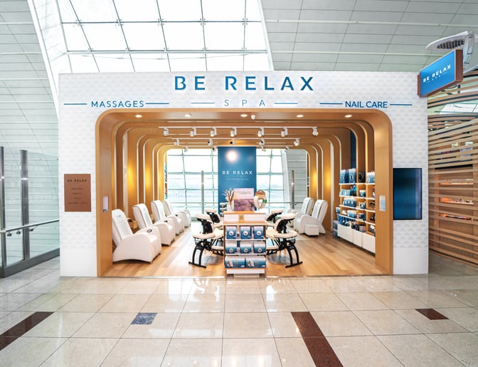 The Be Relax Spa B10 at Dubai International Airport offers massage chairs and nail care services, located near the terminal's main concourse.
