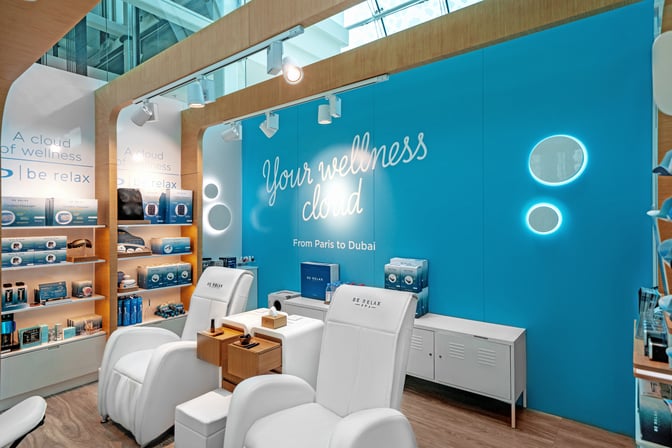 The Be Relax B23 lounge at Dubai International Airport features massage chairs and wellness products for traveler relaxation and comfort.