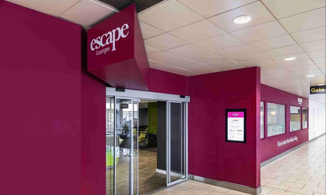 The Escape Lounge entrance at East Midlands Airport features sliding glass doors and is located near Gate 17 in the departure area.