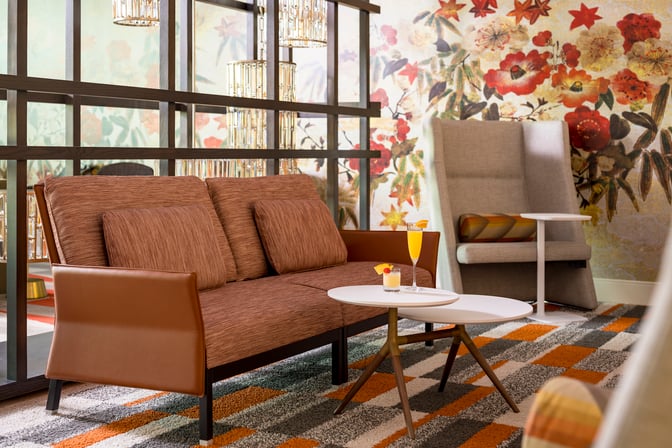 The seating area in the Escape Lounge at Fort Lauderdale Airport features comfortable chairs and tables for relaxation and refreshments.