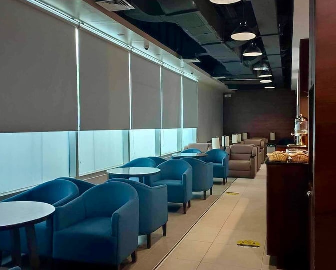 The PAGSS Premium Lounge at Francisco Bangoy International Airport features seating with tables and a self-serve snack area.