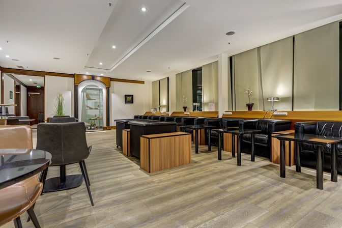 LuxxLounge at Frankfurt Airport features a seating area with individual tables and chairs, providing a comfortable space for travelers.