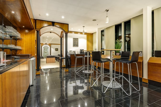 The LuxxLounge at Frankfurt Airport features high-top tables and a bar area with glassware and seating for travelers.