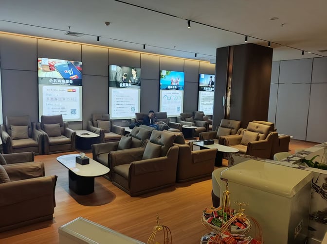 The seating area in the German Business Club lounge at Fuzhou Changle International Airport features comfortable chairs and informational screens.