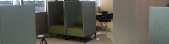 The Nthula Lounge at Sir Seretse Khama International Airport features semi-private seating pods and a nearby table area for travelers.