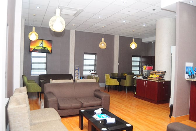 The seating area in Nthula Lounge at Sir Seretse Khama International Airport features sofas, armchairs, and a self-serve snack station.