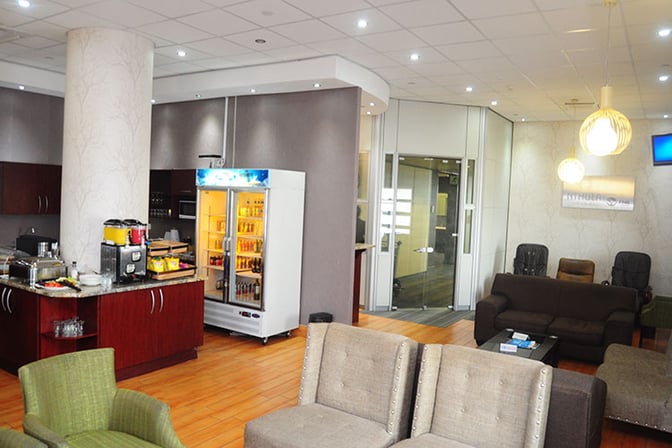 Nthula Lounge at Sir Seretse Khama International Airport features a seating area with sofas and a self-serve beverage station.