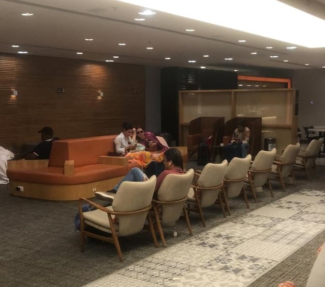 The seating area in GOL Premium Lounge at Rio de Janeiro–Galeão International Airport features comfortable chairs and semi-private booths for relaxation.