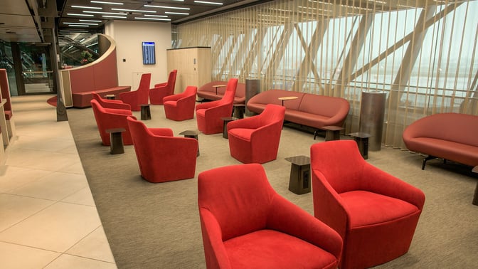 The seating area in the marhaba Lounge at Geneva International Airport features armchairs and sofas with small side tables.