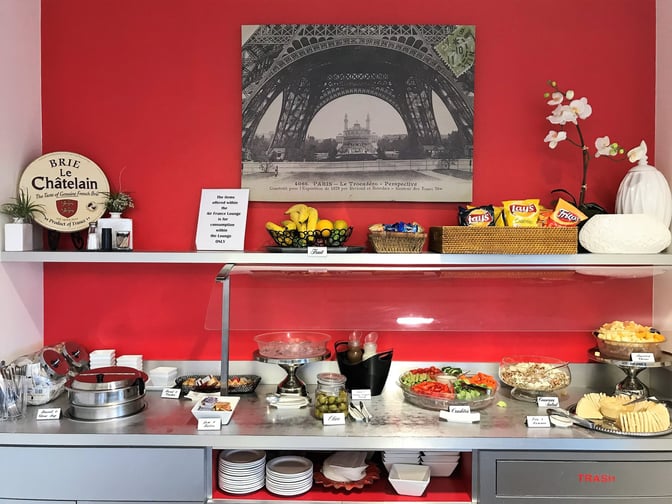 The Air France Lounge at George Bush Intercontinental Airport features a self-serve food station with salads, snacks, and fruit options.