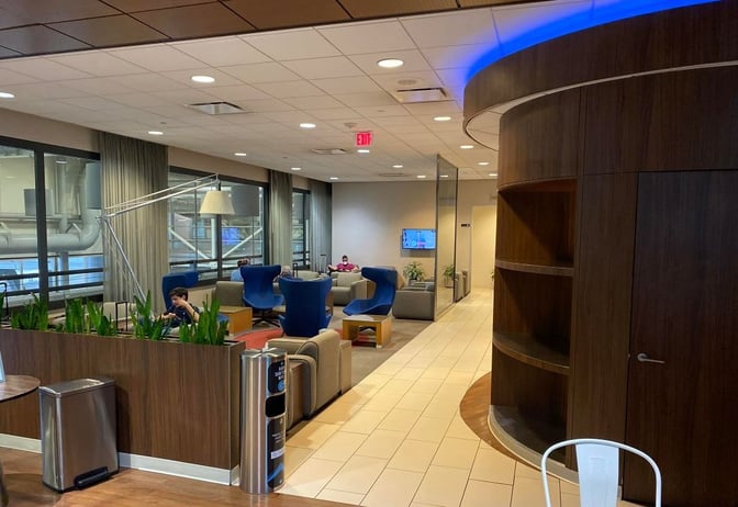 The KLM Crown Lounge at George Bush Intercontinental Airport features a seating area with armchairs and sofas, offering a comfortable space for relaxation.