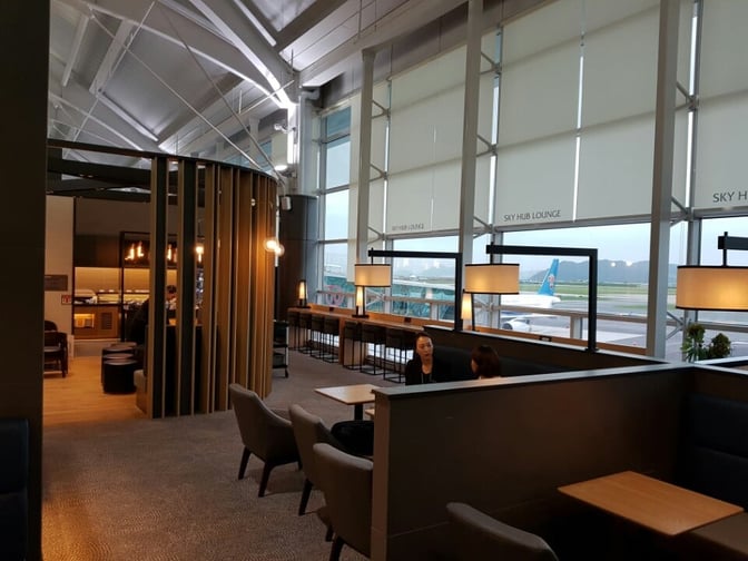 Booth seating at the Sky Hub Lounge in Gimhae International Airport offers semi-private spaces with views of the runway.