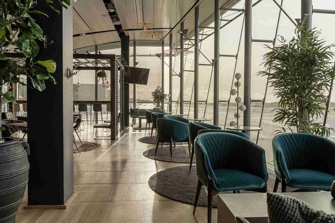 The Lounge by Menzies Aviation at Gothenburg Landvetter Airport features comfortable seating with views of the airport tarmac.