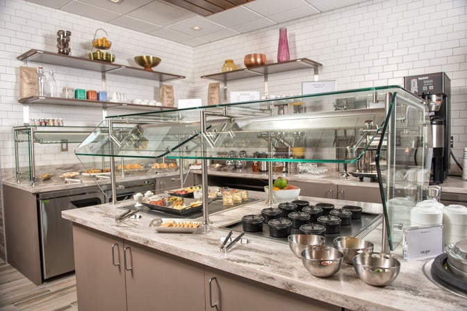 The Escape Lounge at Greenville–Spartanburg International Airport features a self-serve food area with a variety of breakfast options.