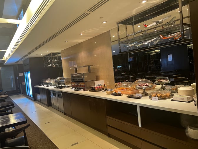 The Sagan Bisita VIP Lounge at Guam International Airport features a self-serve food area with various pastries and snacks available.