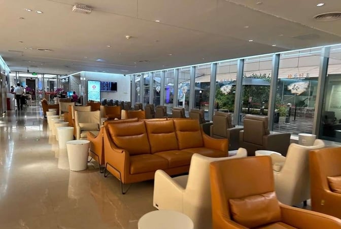Seating in the China Southern Skypearl Lounge at Guangzhou Baiyun Airport includes comfortable chairs and sofas with views of the tarmac.
