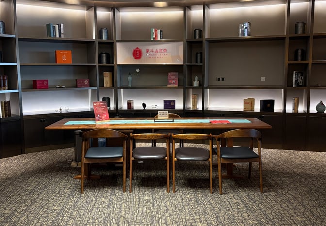 A seating area in the Premium Lounge at Guangzhou Baiyun International Airport features an executive meeting area available upon request.