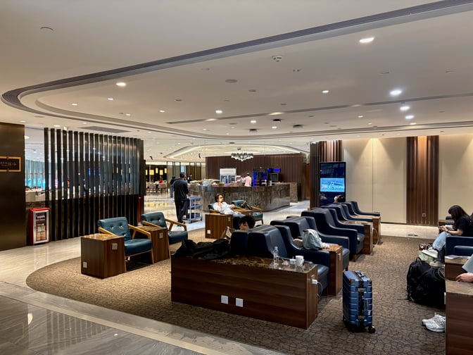 The Premium Lounge at Guangzhou Baiyun International Airport features comfortable seating and a bar area with refreshments available.