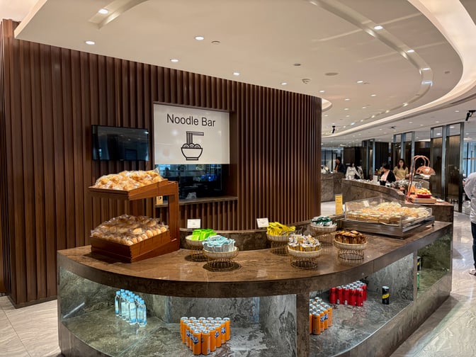 The Premium Lounge at Guangzhou Baiyun International Airport features a Noodle Bar with a variety of snacks and beverages available.