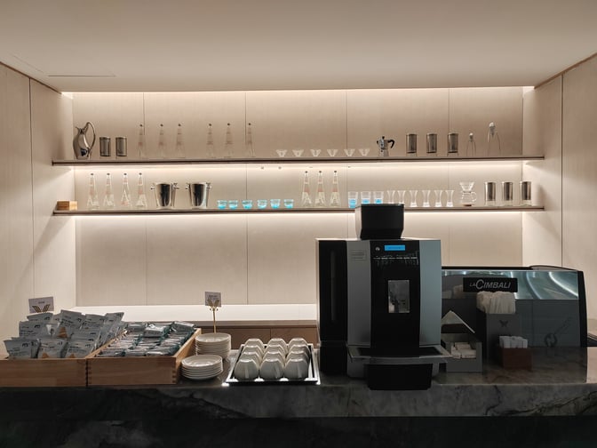 The L34 Lounge at Guangzhou Baiyun International Airport features a self-serve coffee station with a variety of cups and snacks.