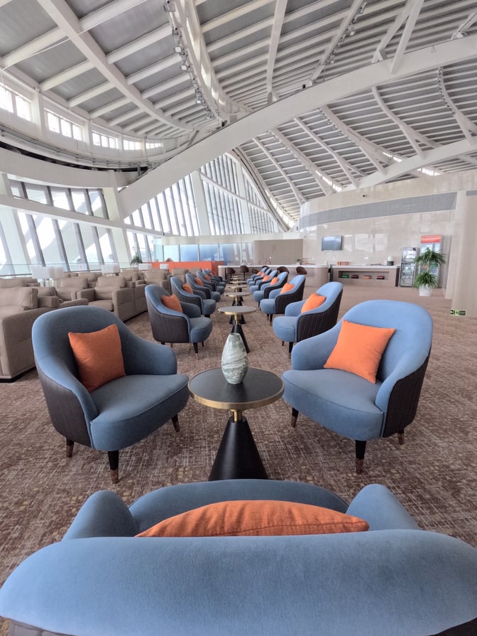 The seating area in Guilin Liangjiang International Airport's First Class Lounge features comfortable chairs and small tables arranged for relaxation.