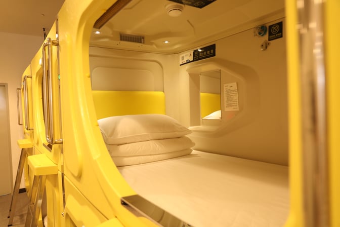 Sleeping pods at Haikou Meilan International Airport offer private resting spaces with bedding and personal amenities for travelers.