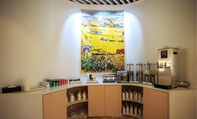 The Trvok Lounge at Haikou Meilan International Airport features a self-serve beverage station with coffee, juices, and soft drinks.