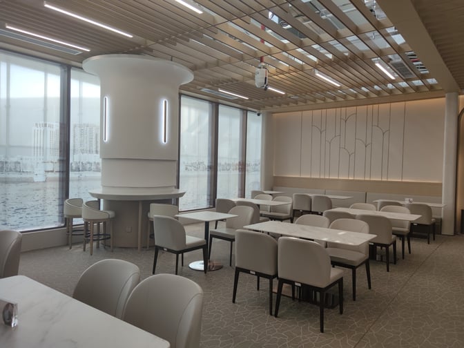 The seating area in Hainan Airlines Lounge at Haikou Meilan International Airport features tables and chairs for dining and relaxation.
