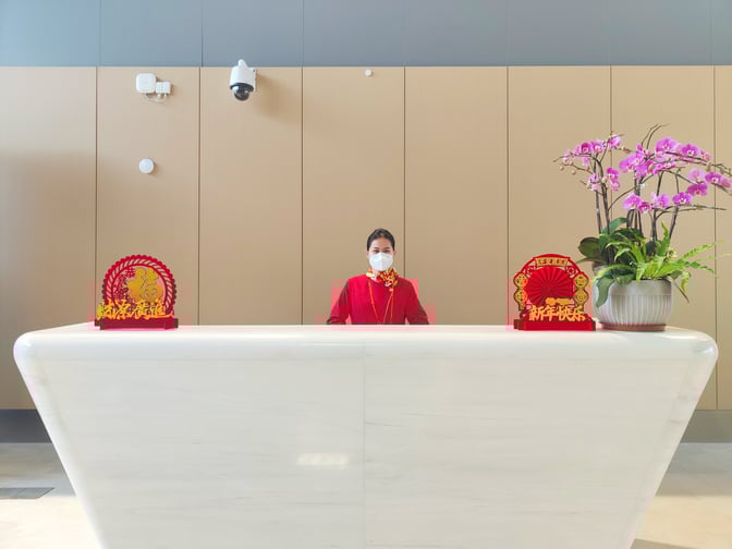 The reception desk at the International First Class Lounge in Haikou Meilan International Airport features decorative elements and a welcoming attendant.