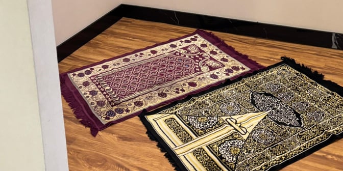 Prayer mats are placed on a wooden floor in a designated prayer area at Saphire Lounge, Halim Perdanakusuma International Airport.