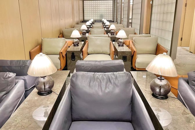 The seating area in VIP Lounge 16 at Hangzhou Xiaoshan International Airport features individual armchairs with personal lamps and side tables.