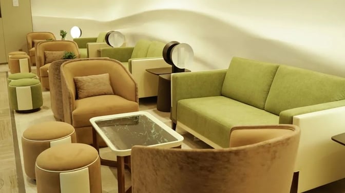 Seating area in VIP lounge V26 at Hangzhou Xiaoshan International Airport features comfortable chairs, sofas, and small tables for relaxation.