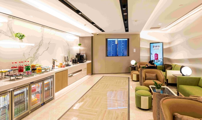 The VIP lounge at Hangzhou Xiaoshan International Airport features a self-serve snack and beverage area with comfortable seating and flight information displays.