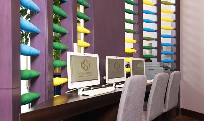 The SH Premium Lounge at Noi Bai International Airport features a business center with computers and seating for travelers.