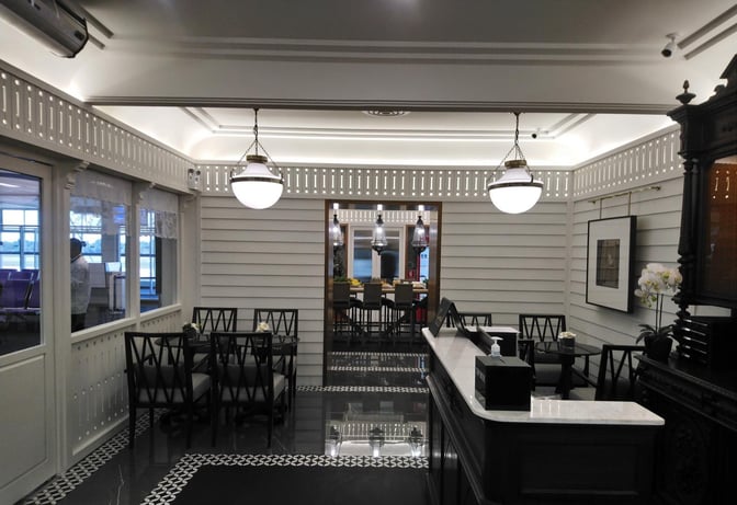 The Coral Executive Lounge at Hat Yai International Airport features a seating area with tables and chairs adjacent to a service counter.