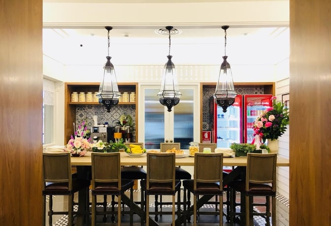 The Coral Executive Lounge at Hat Yai International Airport features a self-serve snack area with seating and beverage options.