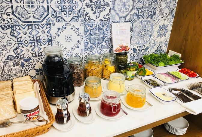 The Coral Executive Lounge at Hat Yai International Airport offers a self-serve breakfast station with breads, spreads, cereals, and fresh vegetables.