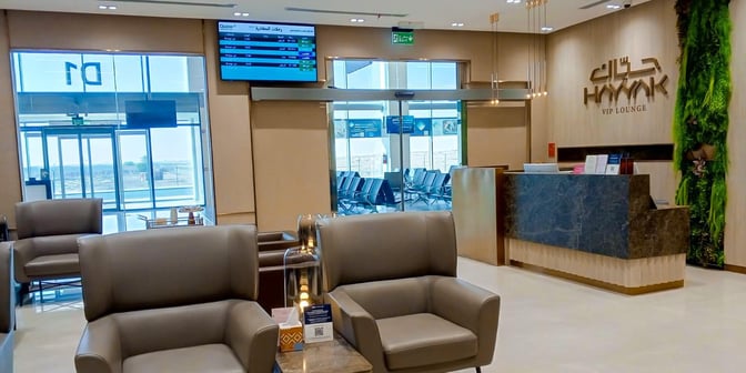 The Hayyak Lounge at Prince Naif bin Abdulaziz International Airport features a reception desk and comfortable seating near the entrance.