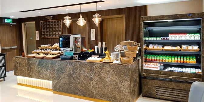 The Hayyak Lounge at Prince Naif bin Abdulaziz International Airport features a self-serve snack and beverage station with a variety of options.