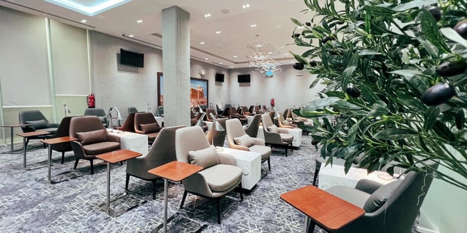 The seating area in Hayyak Lounge at Hail International Airport features individual chairs with side tables and reading lamps.