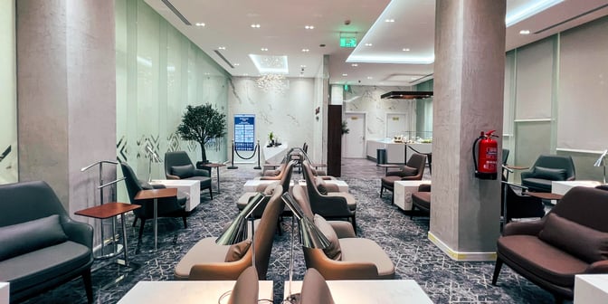 The Hayyak Lounge at Hail International Airport features comfortable seating with tables and lamps, offering a relaxing space for travelers.
