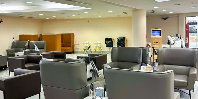 The Hayyak Lounge at Najran Regional Airport features comfortable seating areas with individual lamps and a self-service kiosk.