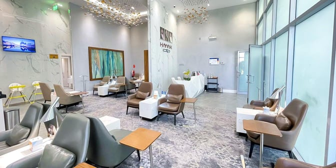The Hayyak Lounge at Ta’if International Airport features comfortable seating with side tables and a reception area for guest assistance.