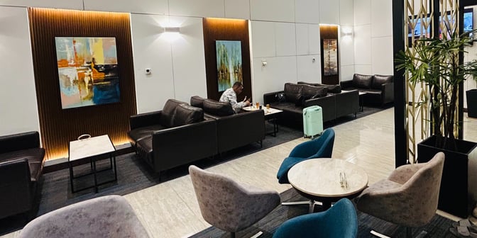 The seating area in UCB Imperial Lounge at Hazrat Shahjalal International Airport features comfortable chairs and tables for dining and relaxation.