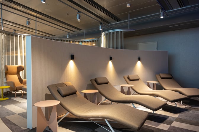 The OP Lounge at Helsinki-Vantaa Airport features a relaxation area with reclining lounge chairs and small side tables for travelers.